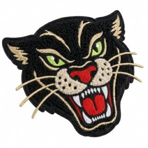 May include: An embroidered patch featuring the head of a black panther with bright green eyes, a red nose, and an open mouth showing white teeth and a red tongue. The design includes tan accents around the eyes, muzzle, and long whiskers.