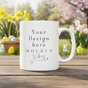 May include: A white ceramic mug with the text "Your Design here MOCKUP Vibes" in black script. The mug is on a wooden surface, with a blurred background of flowers, a basket with eggs, and Easter decorations.