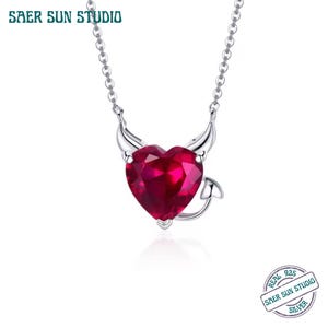 Könnte beinhalten: Eine silberne Halskette mit einem herzförmigen, rubinroten Anhänger. Der Anhänger hat Teufelshörner und einen Schwanz. Die Halskette ist von Saer Sun Studio und mit "Real 925 Silver" gekennzeichnet.