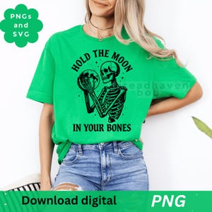 May include: Bright green t-shirt featuring a black graphic of a skeleton holding a moon, with the text "HOLD THE MOON IN YOUR BONES". The shirt also has the words "PNGs and SVG" and "Download digital PNG".