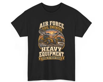 May include: A black t-shirt featuring a graphic print of yellow construction vehicles, a shovel, and a pickaxe. The text reads AIR FORCE CIVIL ENGINEER HEAVY EQUIPMENT KEEPING THE MISSION RUNNING, set against a sunset background with a runway.