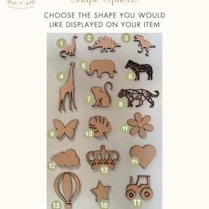 May include: Wooden shape options for personalized items. Includes a dinosaur, giraffe, elephant, zebra, butterfly, flower, cloud, crown, heart, hot air balloon, star, and tractor. Text reads "Shape Options" and "Choose the shape you would like displayed on your item."
