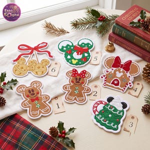May include: A collection of six decorative holiday-themed ornaments featuring gingerbread characters, a wreath, and jingle bells, each with a numbered tag. The designs include Mickey and Minnie Mouse motifs, candy canes, and bows, arranged on a white cloth.