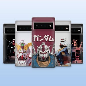 May include: A collection of phone cases featuring robot illustrations. The cases display various robot designs in red, white, blue, and yellow. The central case has the Japanese word "Gundam" printed in white on a maroon background.