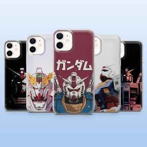 May include: A collection of phone cases featuring colorful illustrations of mecha robots. The cases display various robot designs with detailed artwork and the Japanese word "ガンダム" in white. The cases are in a row, showcasing different angles and styles.