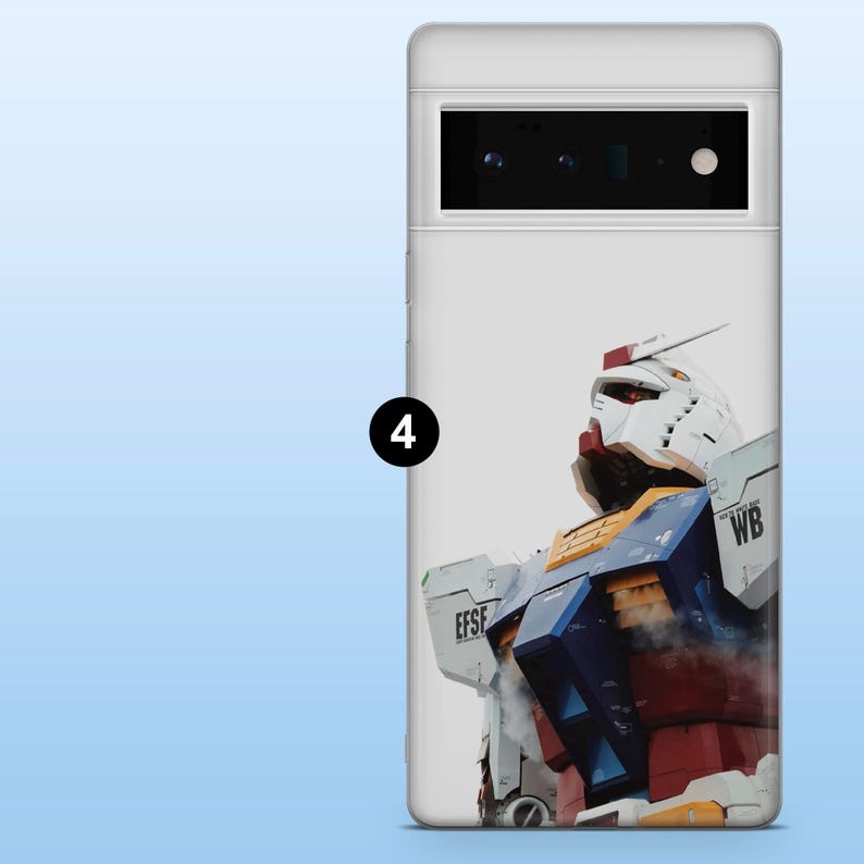 May include: A white phone case featuring a detailed illustration of a Gundam robot. The robot is primarily white, with accents of red, blue, and yellow. The case has a sleek design and a camera cutout.