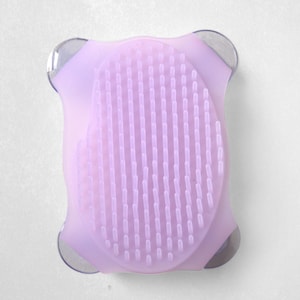 May include: A lavender silicone bath brush with a textured surface and suction cups on the back.