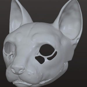 May include: A detailed, off-white cat skull mask with large, pointed ears and hollow eye sockets. The mask has a realistic, textured surface and a slightly open mouth, showcasing the teeth. The overall design suggests a Halloween or cosplay theme.