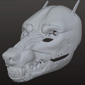 Può includere: Una scultura grigio chiaro di un teschio canino con elementi meccanici. La scultura presenta denti, un naso strutturato e aperture per gli occhi. Il design combina elementi organici e tecnologici.