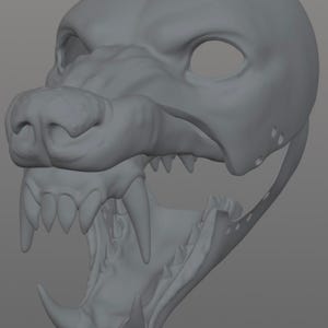 Puede incluir: Un cráneo canino gris impreso en 3D con la boca abierta que revela dientes afilados. El cráneo presenta un esculpido detallado del hocico, las cuencas de los ojos y la mandíbula, que sugiere un lobo o un perro.