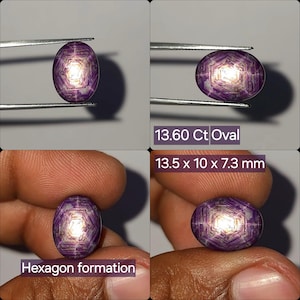 May include: An oval-shaped purple gemstone featuring a distinct internal hexagon formation and a bright central light reflection. The stone is labeled as 13.60 Ct and measures 13.5 x 10 x 7.3 mm, displaying a deep violet hue with geometric patterns.