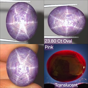 May include: A 23.80 Ct oval pink star sapphire gemstone featuring a translucent appearance and a distinct six-rayed star pattern visible on its surface. The stone displays a light purple hue with internal geometric patterns and light reflections.