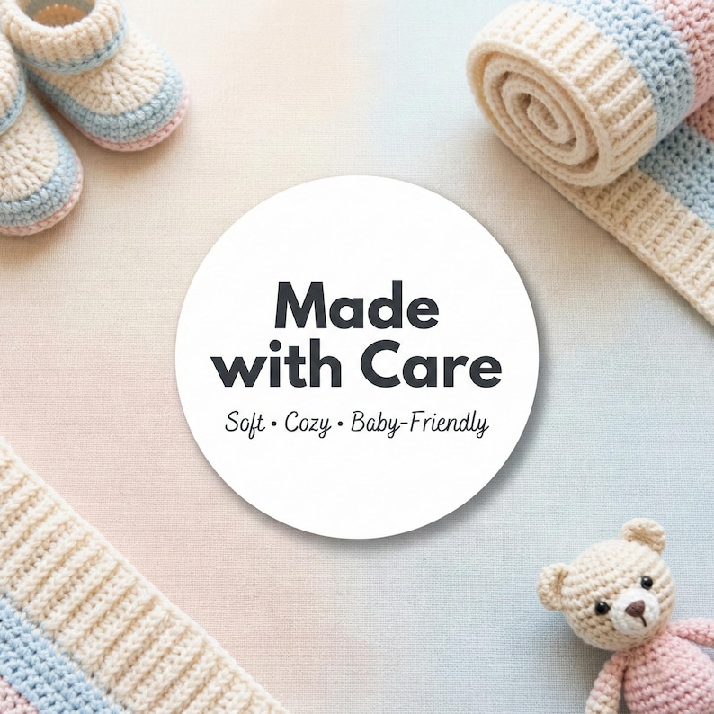 May include: A soft, baby-friendly crochet set in pastel colors. The image features a rolled blanket, booties, and a teddy bear, all in cream, pink, and blue. A white circle with the text "Made with Care" is in the center.
