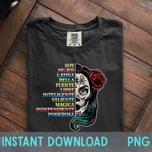 May include: Dark grey t-shirt with a sugar skull graphic and Spanish text including "Soy", "Mujer", and "Latina". A red rose adorns the skull. The shirt also has the words "Instant Download PNG".
