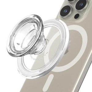 May include: A clear, circular phone grip with a transparent base, attached to a smartphone. The grip is designed to be collapsible and features a textured surface for enhanced grip. The phone case is a light beige color.