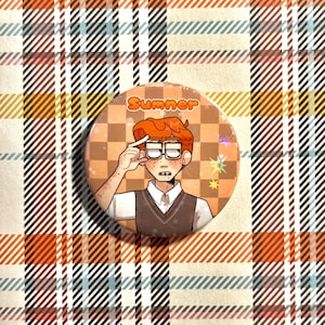 May include: A circular pinback button featuring an illustration of a person with orange hair and glasses, wearing a white shirt and dark vest. The background is an orange and tan checkerboard pattern with the text Sumner printed at the top.