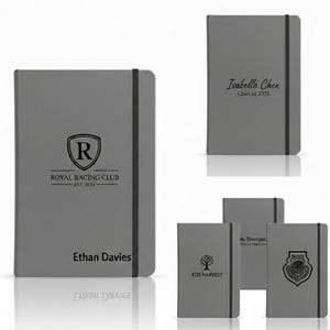 May include: Gray notebooks with black elastic closures. One notebook features the text "ROYAL RACING CLUB EST. 2023" and "Ethan Davies". Another has "Isabella Chen Class of 2025". Other notebooks have logos and text.