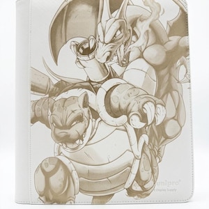 May include: A white binder featuring a monochromatic brown line art illustration of the Pokémon characters Charizard and Blastoise. The design shows Charizard with wings spread and Blastoise in a dynamic pose. The text Unipro Card Display Supply is visible.