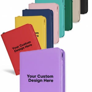 May include: A collection of zippered binders in various colors, including red, yellow, blue, pink, teal, green, beige, and black. Each binder has the text "Your Custom Design Here" printed on the front. The brand name "vaultx" is visible on the purple binder.