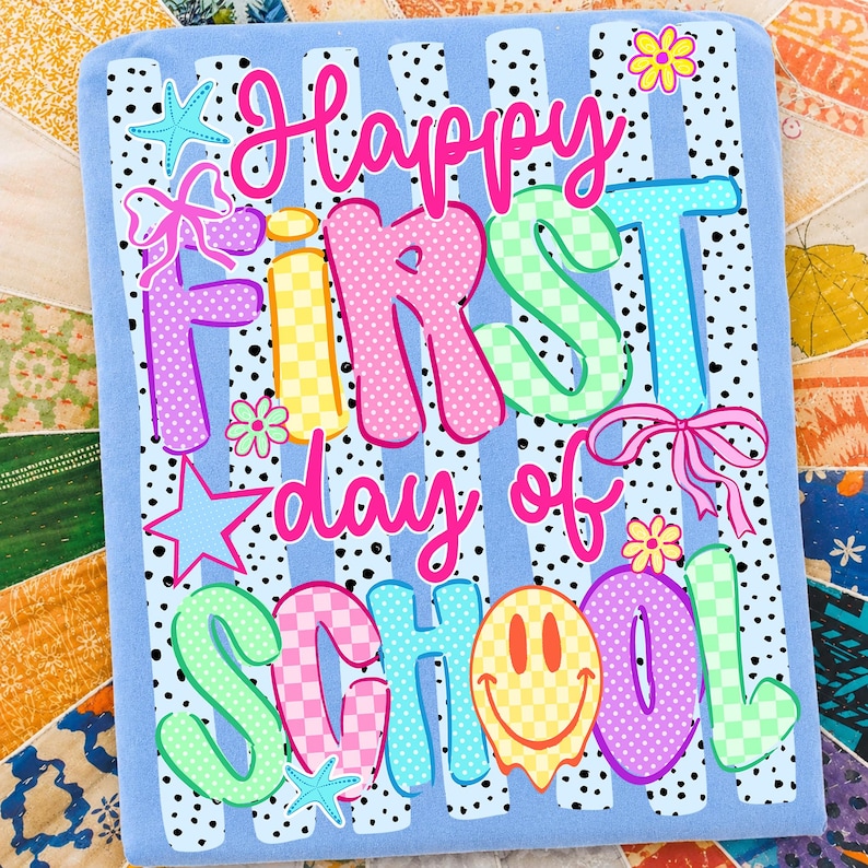 May include: A light blue rectangular fabric panel featuring the text Happy First day of SCHOOL in colorful, patterned bubble letters. The design includes black polka dots, pink bows, yellow flowers, blue starfish, and a yellow smiley face icon.