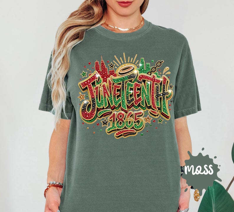 A woman wearing a green t-shirt with a colorful graphic design that says "JUNEENTH 1865" and includes various decorative elements such as stars, rays, and splashes of color.