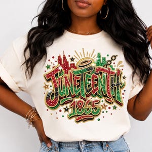 A woman wearing a white t-shirt with a colorful graphic design that says "JUNE TEEN 1865" and features various decorative elements such as stars, hearts, and a city skyline.