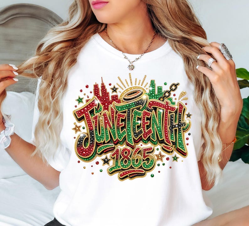 A woman with long, wavy blonde hair wearing a white t-shirt with a colorful graphic design that says "JUNE EENTH" and "1865".