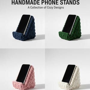 May include: Four handmade phone stands in navy, green, pink, and white, each holding a black smartphone. The stands have a textured, cosy design. The text reads "HANDMADE PHONE STANDS" and "A Collection of Cozy Designs".