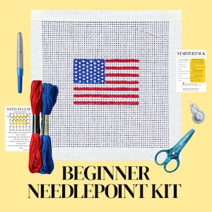 May include: Beginner needlepoint kit featuring an American flag design. Includes a canvas with the flag pattern, red and blue embroidery thread, scissors, a needle, a needle threader, and a stitch guide. The words "BEGINNER NEEDLEPOINT KIT" are at the bottom.