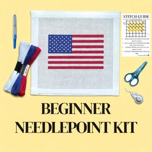 May include: A beginner needlepoint kit featuring a canvas with the American flag design. The kit includes embroidery floss in red, white, and blue, a needle, scissors, and a stitch guide. The text "BEGINNER NEEDLEPOINT KIT" is displayed.