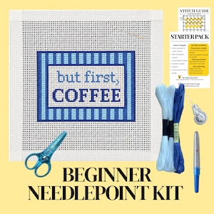 May include: A needlepoint kit featuring a white canvas with a blue striped border and the text but first, COFFEE in blue. Includes light and dark blue embroidery thread, blue scissors, a needle threader, a needle, and a stitch guide.