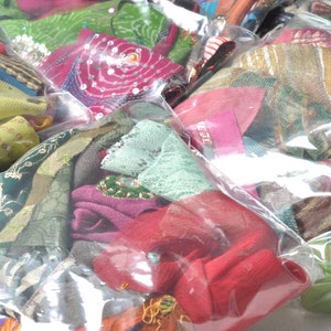 May include: Assortment of colorful fabric scraps in various textures and patterns, packaged in clear plastic bags.