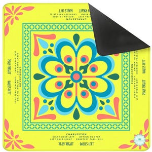 This is a mahjong mat with a brightly colored tile in the center.