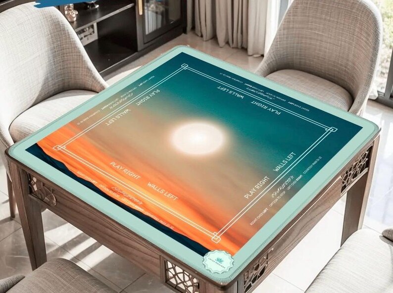 May include: A wooden game table with a glass top featuring a sunset design in shades of orange, blue, and white. The table has decorative side panels and is surrounded by two chairs. Text on the table reads "PLAY RIGHT" and "WALLS LEFT".