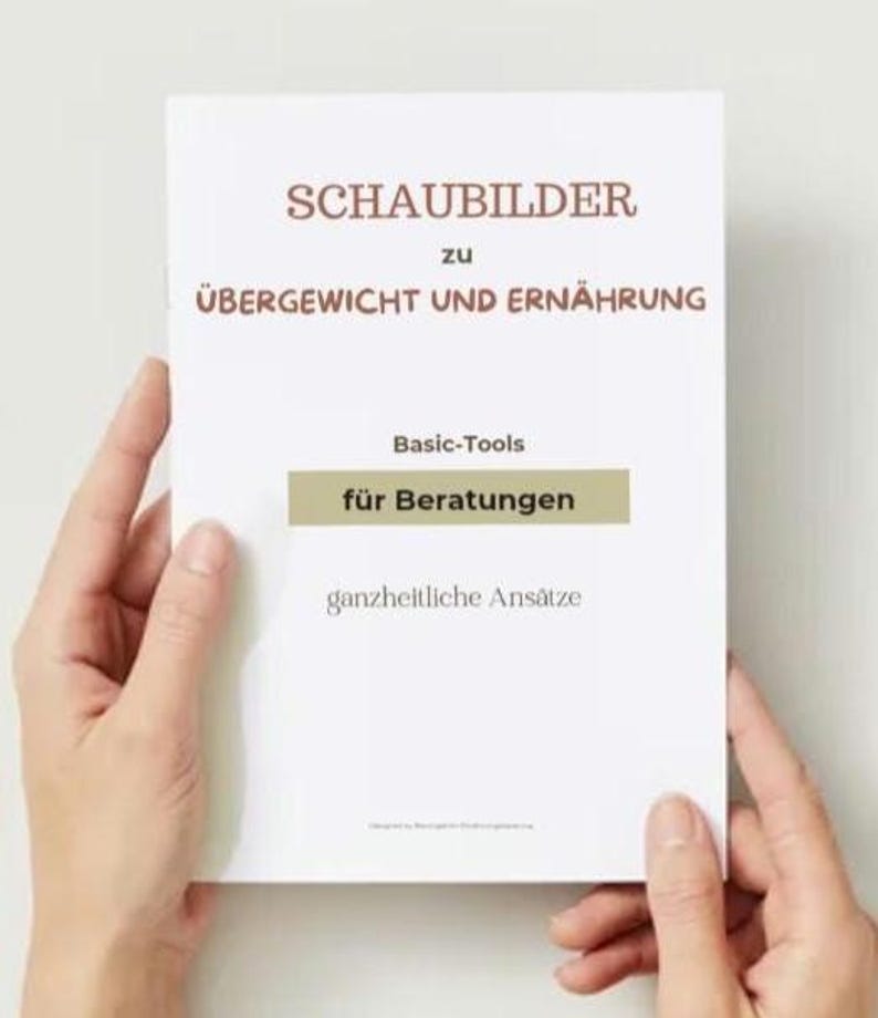 Puede incluir: Un libro blanco titulado "SCHAUBILDER zu &Uuml;BERGEWICHT UND ERN&Auml;HRUNG" es sostenido por dos manos. El libro tiene texto que dice "Basic-Tools f&uuml;r Beratungen" y "ganzheitliche Ans&auml;tze". La portada tiene texto marr&oacute;n y dorado.