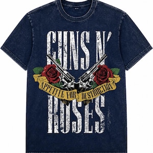 May include: A dark blue acid-wash t-shirt featuring a graphic print of two crossed revolvers, two red roses, and a yellow banner with the text "APPETITE FOR DESTRUCTION". The words "GUNS N' ROSES" are printed in large, distressed white lettering.
