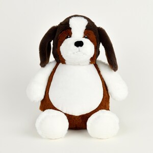 May include: A plush St. Bernard dog toy with brown, white, and black fur. The stuffed animal has long floppy ears, a white chest, and white paws. The dog is sitting upright and facing forward.