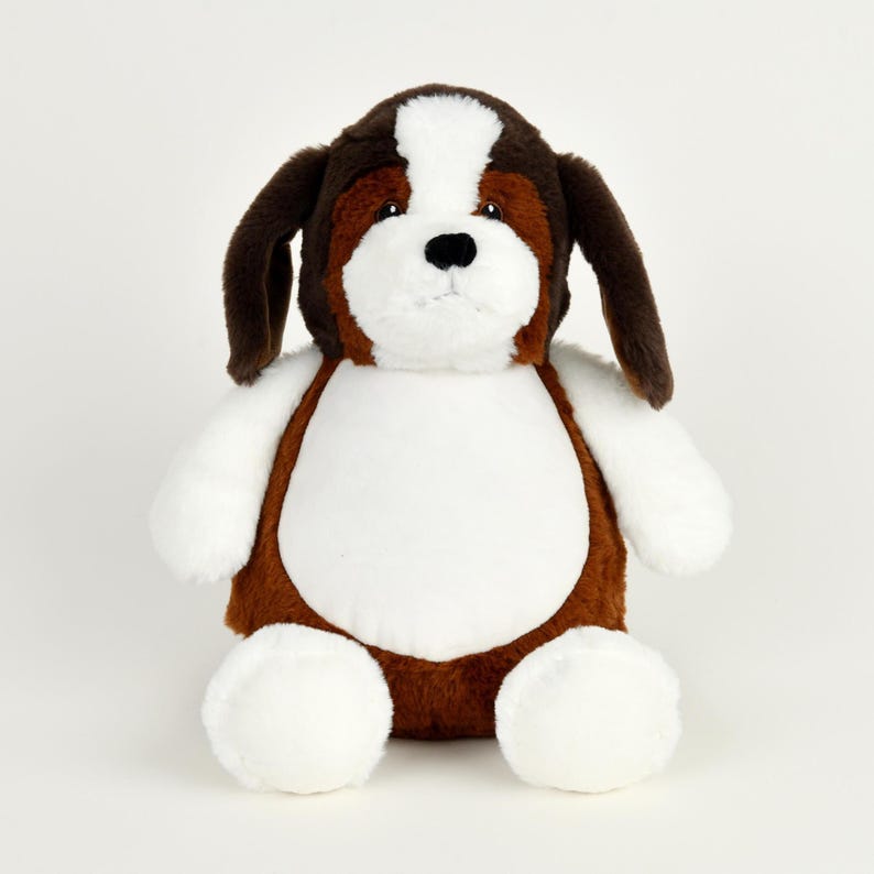May include: A plush St. Bernard dog toy with brown, white, and black fur. The stuffed animal has long floppy ears, a white chest, and white paws. The dog is sitting upright and facing forward.