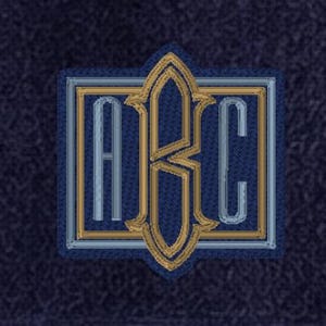 May include: A square-shaped embroidered patch featuring the letters A, B, and C. The letter B is centered and larger, flanked by the letters A and C. The design uses gold and light blue thread on a dark blue textured fabric background.