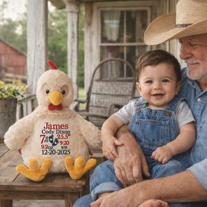 May include: A plush beige chicken toy with a red comb and yellow feet. The chest features embroidered text: James, Cody Dixon, 7 lbs 9.2 oz, 25.5 inches, 9:20 am, and 12-20-2025, accompanied by two small blue footprint icons.
