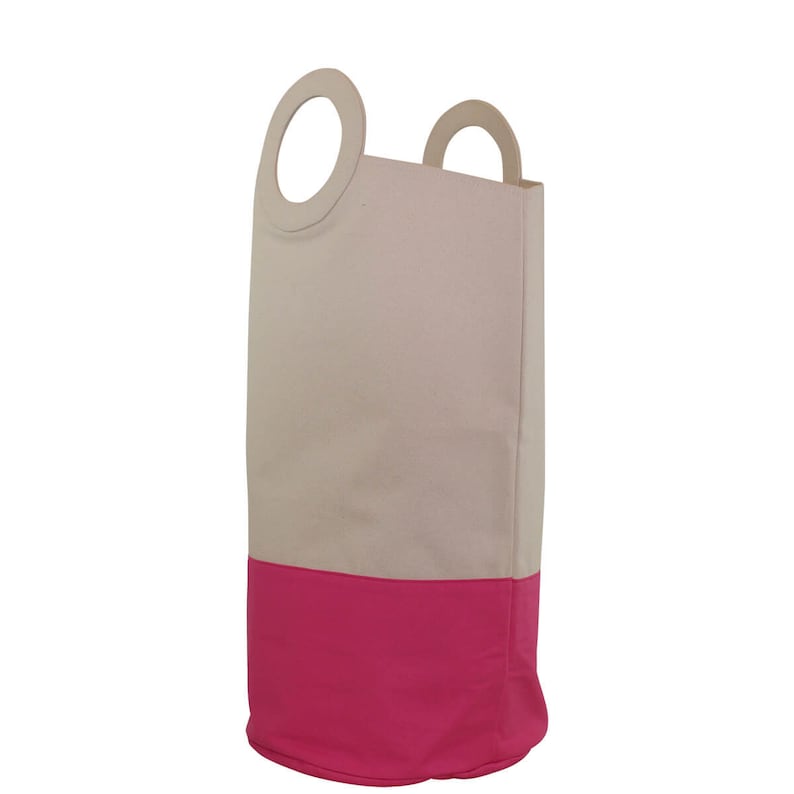 May include: A beige canvas laundry hamper with a pink bottom and two wooden handles. The handles have a circular cutout.