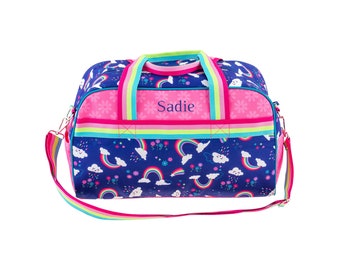 May include: A blue and pink duffel bag with a rainbow and cloud print. The bag has a personalized name tag that says "Sadie".