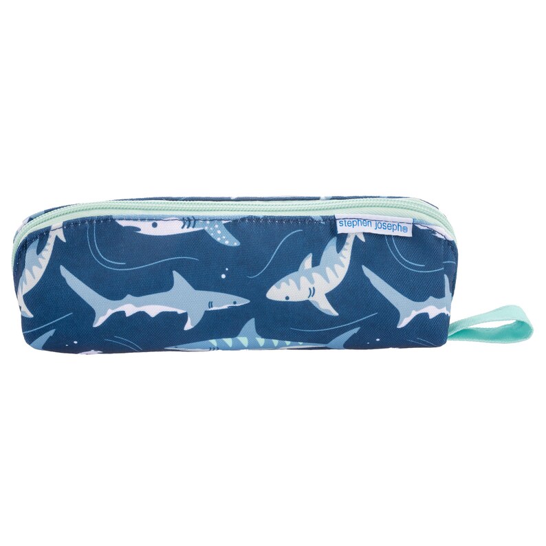 May include: A navy blue pencil case with a repeating pattern of white and light blue sharks. The pencil case has a light blue zipper and a matching pull tab. The brand name "stephen joseph" is printed on the side.