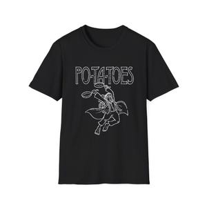 May include: Black t-shirt with a white graphic of a character holding pans and the word "POTATOES" above. The graphic has a distressed, vintage look. The shirt is a crew neck and appears to be made of cotton.