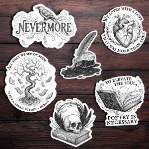 May include: A collection of black and white stickers with gothic and literary themes. Designs include a raven with the word "Nevermore", a heart, a tree with books, a skull on a book, an inkwell with a quill, and an open book with the text "Poetry is Necessary".
