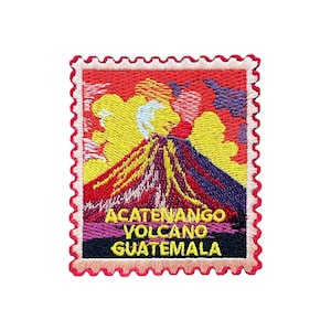 May include: Embroidered patch depicting Acatenango Volcano in Guatemala. The design shows an erupting volcano with yellow, orange, and red colours, set against a vibrant sky. The text "ACATENANGO VOLCANO GUATEMALA" is displayed on the patch.