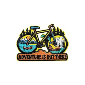 May include: Embroidered patch featuring a yellow bicycle with a mountain and lake scene in the wheels. A hiking boot and map are on the right wheel. The text "ADVENTURE IS OUT THERE" is at the bottom.