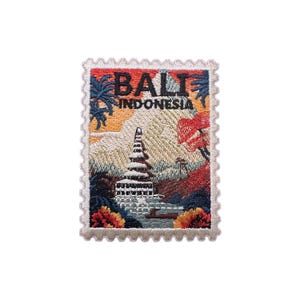 May include: Embroidered patch in the shape of a postage stamp, displaying a Balinese temple and the text "BALI INDONESIA." The patch has a cream border and shows a colourful landscape with palm trees, mountains, and flowers.