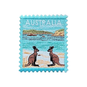 May include: Embroidered patch featuring a stylized design of two kangaroos on a beach with a turquoise ocean and cliffs in the background. The word "AUSTRALIA" is embroidered across the top in white.