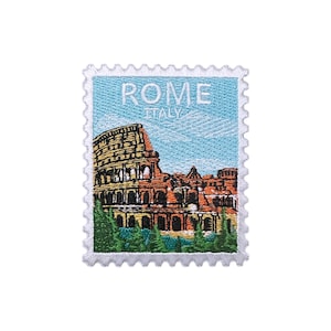 May include: Embroidered patch in the shape of a postage stamp featuring the Colosseum in Rome. The patch has a light blue background with the words "ROME ITALY" in white. The Colosseum is depicted in shades of brown and yellow.